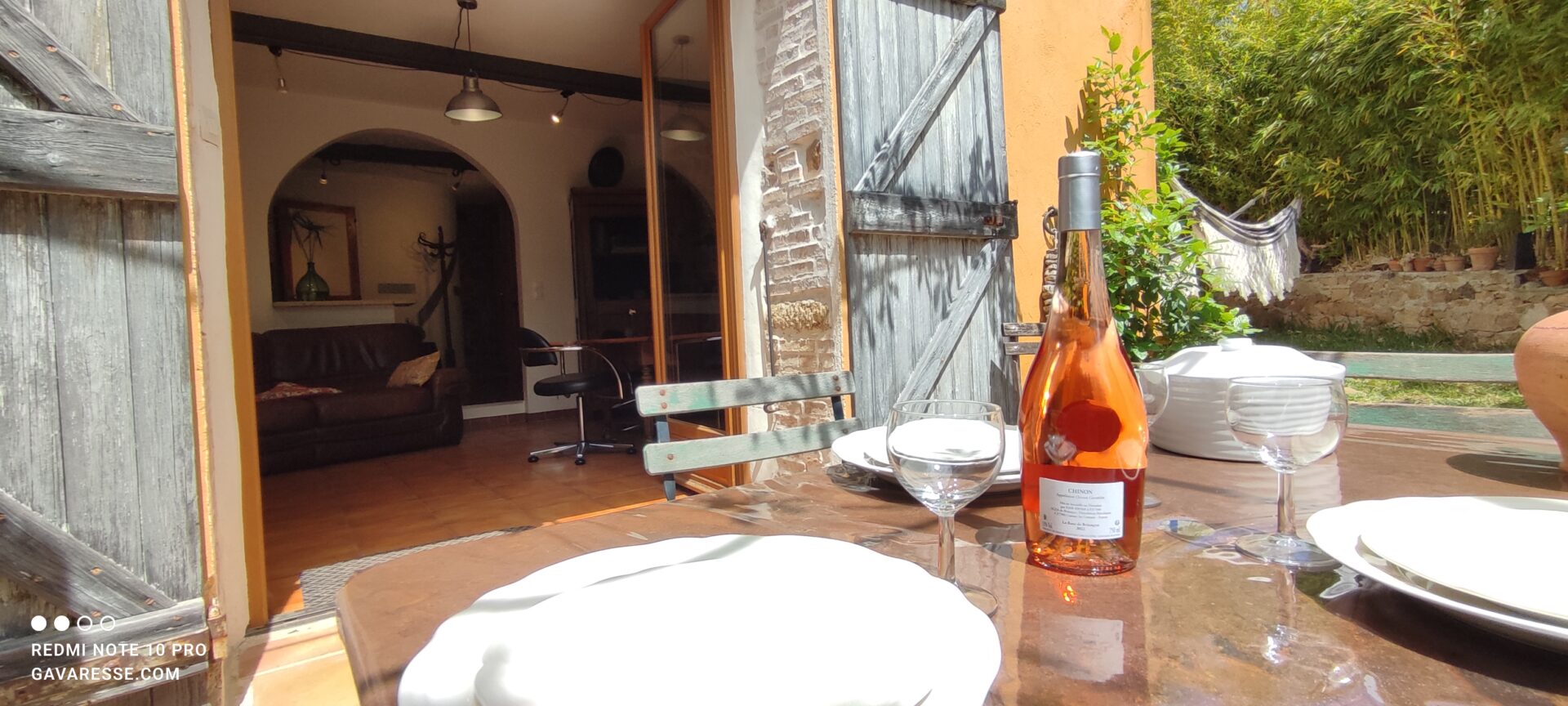 Table dressée sur la terrasse du gîte Le Pénéquet avec bouteille de rosé, devant l'accès au séjour, Le Pradet.